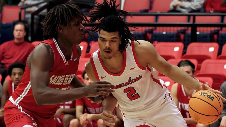 Stony Brook forward Frankie Policelli drives the baseline against the...