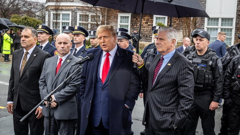 Former president Donald Trump, second from right, is flanked by...