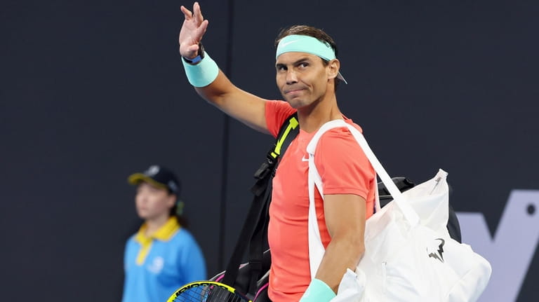 Rafael Nadal, of Spain, waves to the crowd at his...