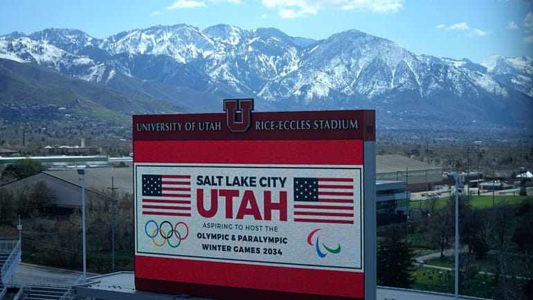 The scoreboard at the University of Utah's Rice-Eccles Stadium promotes...