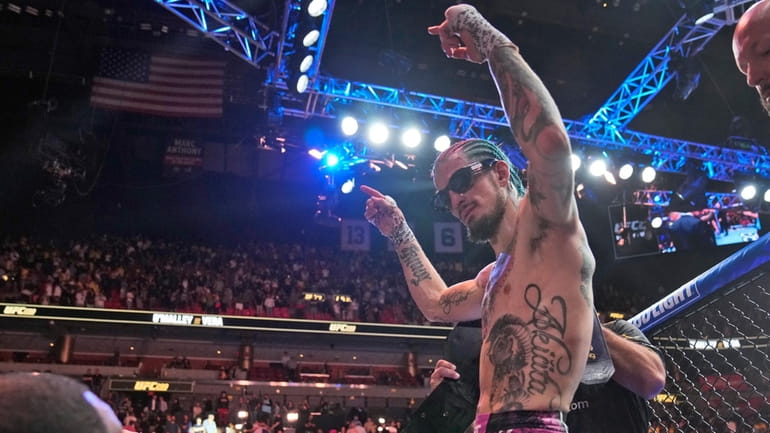 Sean O'Malley celebrates after retaining his UFC bantamweight title against...