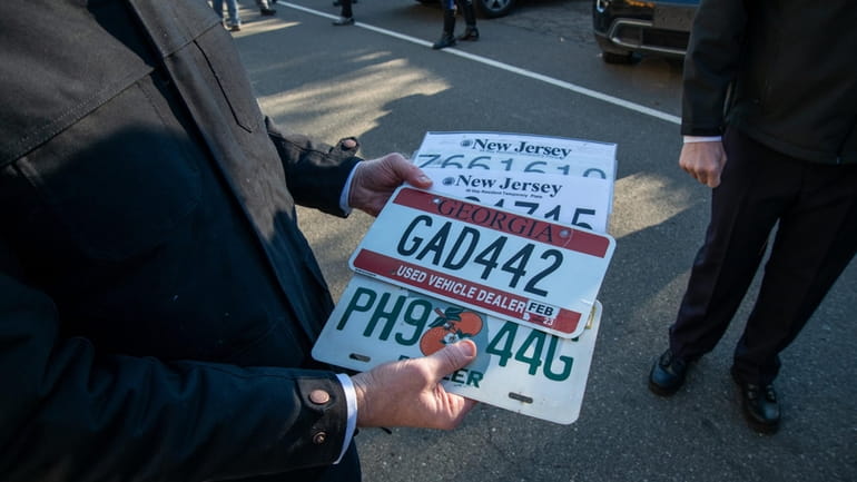 MTA chairman Janno Lieber with license plates of toll violators...