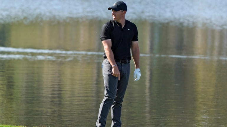 Rory McIlroy, of Northern Ireland, points to near where his...