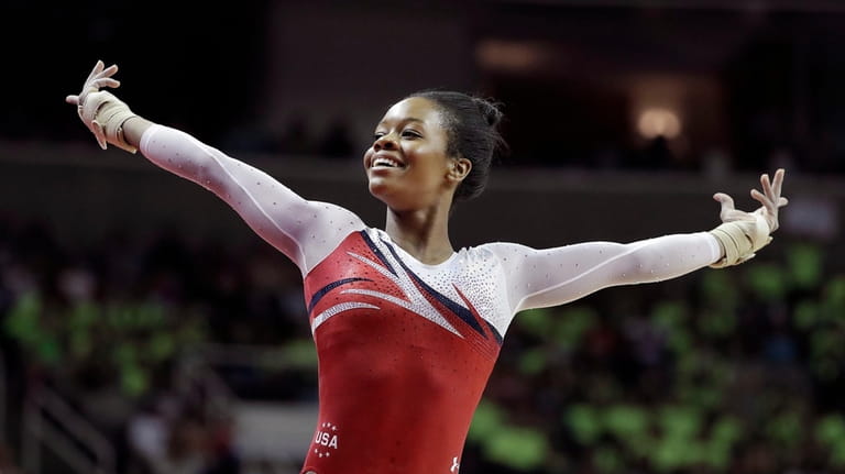 Gabrielle Douglas smiles after competing on the floor exercise during...
