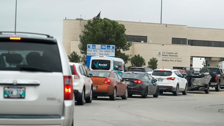 Traffic backs up at the border crossing from Manitoba, Canada,...